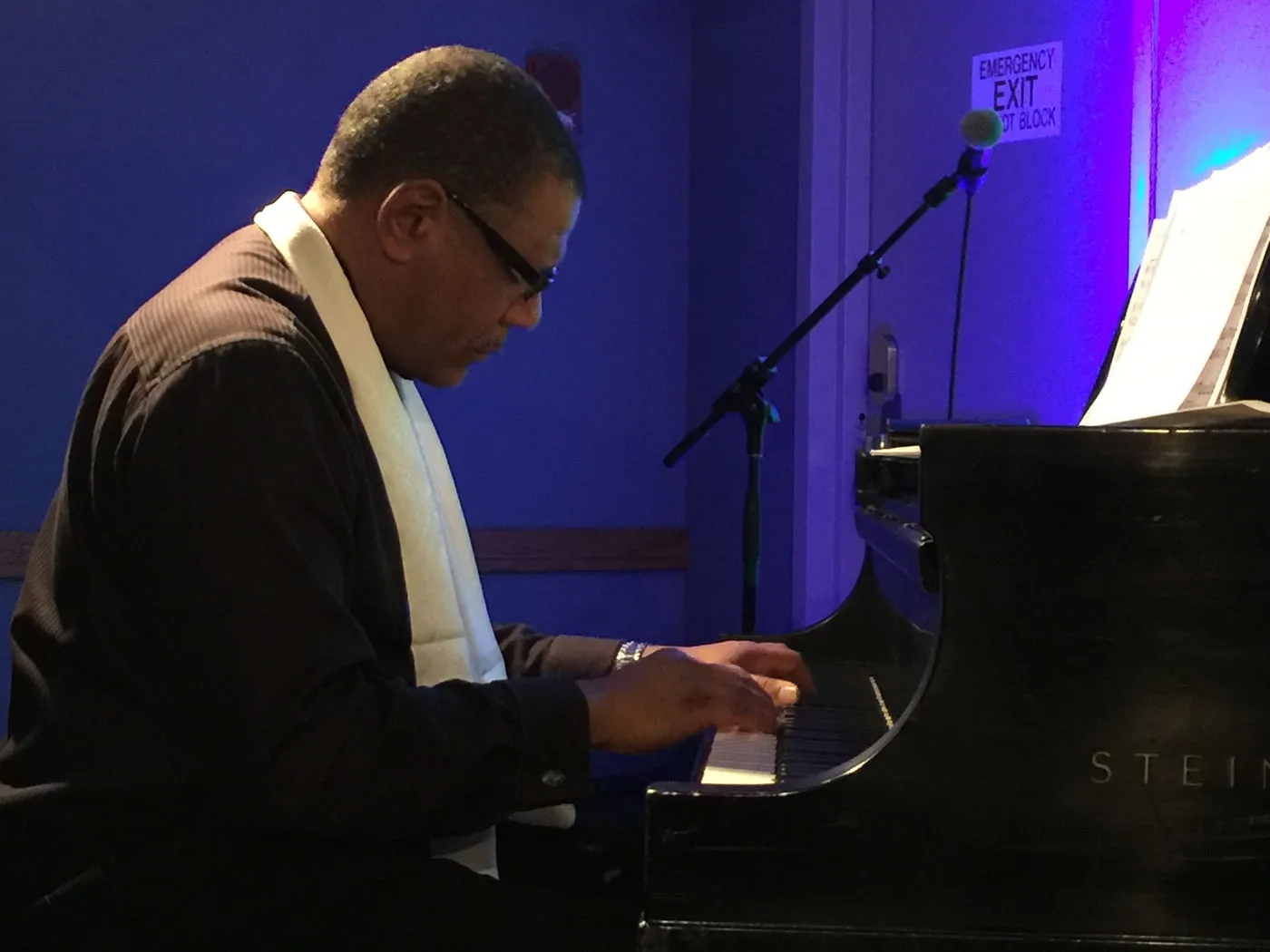 Donal Fox at the piano, blue-lit room